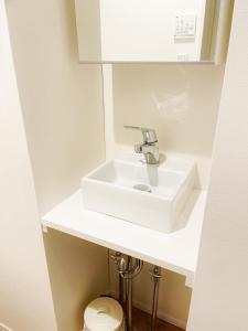 a bathroom with a white sink and a toilet at Chill Fortuna Shimokitazawa Tokyo in Tokyo