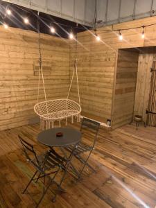 サン・シャモンにあるLove Room, studio Woody Spa , Balnéoのテーブルと椅子、ブランコ付