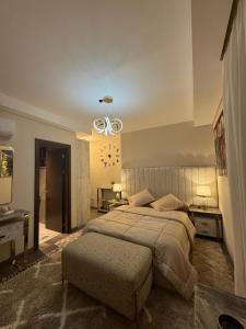 a bedroom with a large bed and a ceiling fan at Zed towers El sheikh ZAYED zed park 3 in Sheikh Zayed