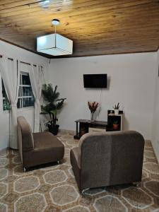 a living room with a couch and a chair at Hospedaje Namasol in La Quiaca