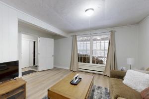 a living room with a couch and a table at Lower A-Frame Escape in Ludlow +5 photos