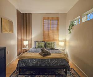 a bedroom with a large bed with two lamps at Brimfield Stay in Los Angeles +17 photos