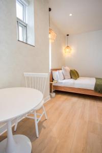 a room with a bed and a table and a couch at Studio #18 - Self Check-In - Plateau - St-Denis in Montreal