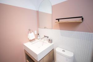 a bathroom with a white sink and a toilet at Studio #18 - Self Check-In - Plateau - St-Denis in Montreal