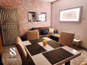 a dining room with a table and a living room at Casa Scarlett in Cartagena de Indias
