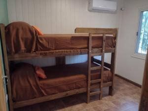a couple of bunk beds in a room at VerdeMonte - Cabaña Lapacho in Leandro N. Alem