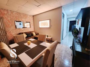 a dining room with a table and a couch at Casa Scarlett in Cartagena de Indias