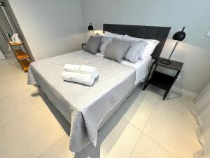 a bedroom with a large bed with two towels on it at Conforto e praticidade a 2 minutos do centro in Nova Friburgo