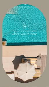 a sign for the sun shines brighter when youre here with an umbrella at Sewelo Suites - Beachfront Boutique Suites in Skinária