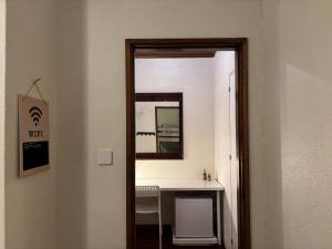 a mirror in a bathroom with a vanity and a sink at Casa Alba in Mindelo