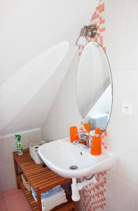 a bathroom with a sink and a mirror at Apartments Odměny U Třeboně in Třeboň