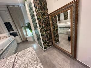 a mirror in a room with a bed and a bedroom at Apartamento in Donostia-San Sebastián +60 photos