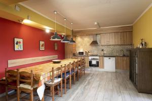 a kitchen with a large wooden table and chairs at S&C Apartments in Ilha da Madeira