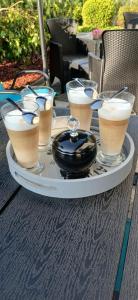 a tray with several drinks on a table at Willa La mer-Balia z jacuzzi, sauna ,klimatyzacja ,rowery in Ustka