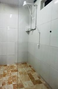 a shower with a glass door in a bathroom at Chalé Privativo Surfers Itaguá in Ubatuba