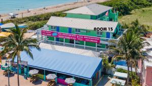 an overhead view of a beach resort with palm trees at Oceanfront Inn Room #15- Inlet View- King Bed in Fort Pierce +18 photos