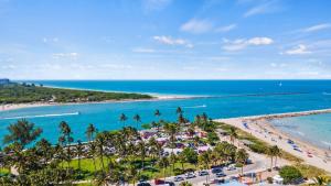 an aerial view of a beach with palm trees and the ocean at Oceanfront Inn Room #10- Standard Room - King Bed in Fort Pierce