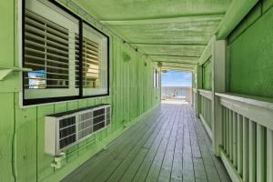 an empty hallway of a green building with a balcony at Oceanfront Inn Room #11- Standard Room - King Bed in Fort Pierce