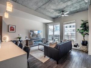 a living room with a couch and a table at Designer - by Convention Center Pool, HTub, 24-7 Gym in Salt Lake City +37 photos