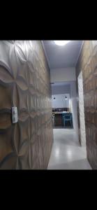 a hallway with a wooden wall with a light on it at Residencial Franco Casa 02 in Primavera do Leste