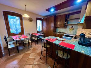 a kitchen with a bunch of tables and chairs at Casa Experience - Venas Di Cadore in Venas +35 photos
