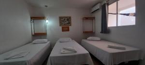 a room with two beds and a window at HOTEL CAJUINA AVENIDA in Teresina +5 photos