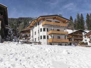 a building on top of a snow covered slope at Tirolee Marchegg in Oberau