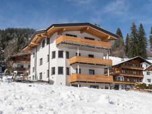 a building with snow in front of it at Tirolee Marchegg 2 OG Top 4 in Oberau