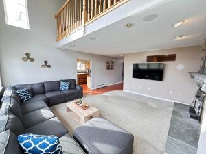 a living room with a couch and a flat screen tv at Lake House in Newport Maine in Loon Island