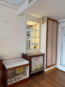 a room with an empty refrigerator with a shelf at Hua Tong Hotel in Hualien City