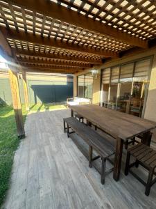a wooden table and benches on a patio at Casa hacienda in Los Ángeles