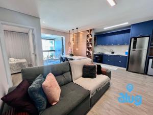 a living room with a couch and a kitchen at Vista Mar Próximo ao Beto Carrero - Cond. Club in Piçarras