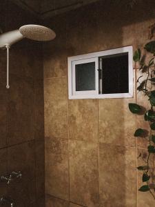 a bathroom with a window and a shower at Casa de luz in Posadas +10 photos