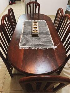 a wooden table with a cell phone sitting on top of it at Casa de luz in Posadas