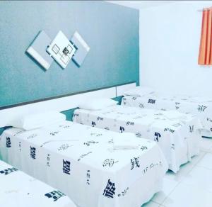 a group of white mattresses in a room at Hotel Dom Cláudio in Fortaleza