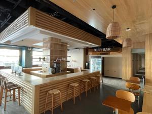 a restaurant with a bar with chairs and a counter at Dengba Inn-Shanghai New World Plaza Branch in Shanghai
