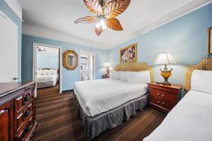 a hotel room with two beds and a chandelier at Fitzgerald Hotel Union Square in San Francisco