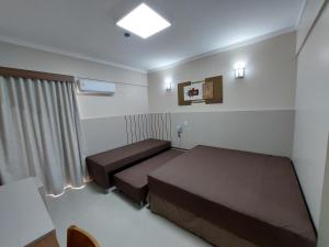 a small room with two beds and a window at Spazzio diRoma - Apartamentos JN in Caldas Novas +68 photos