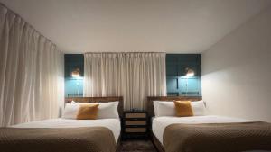 two beds sitting next to each other in a room at Seaside Serenity in Daytona Beach