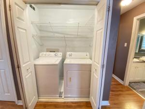 a washer and dryer in a small kitchen at Rustyc Charm Meets Modern Comfy in Dieppe +39 photos