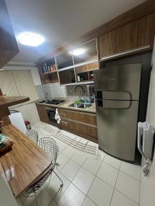 a kitchen with a refrigerator and a table and chairs at Apt-igorss-aju in Aracaju