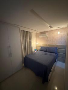 a bedroom with a blue bed and a white cabinet at Apt-igorss-aju in Aracaju