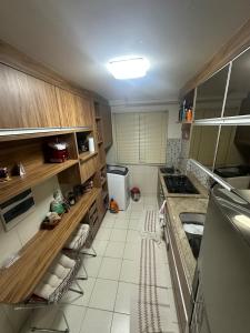 a small kitchen with a sink and a stove at Apt-igorss-aju in Aracaju +5 photos