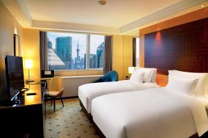 a hotel room with two beds and a window at Radisson Collection Hyland Shanghai in Shanghai