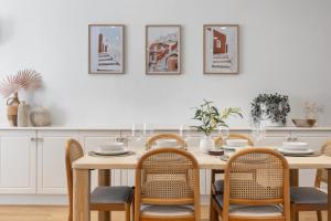 a dining room with a wooden table and chairs at Mediterranean Muse - 3BR, Wi-Fi, Parking in Unley