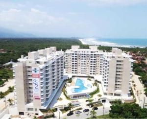an aerial view of a large apartment building with a pool at Lindo Apto entre 2 praias in Bertioga +17 photos