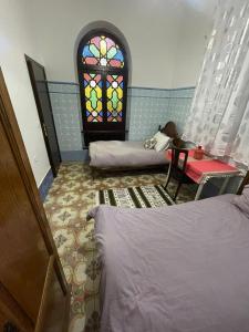 Ένα ή περισσότερα κρεβάτια σε δωμάτιο στο Chambre centrale