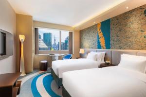a hotel room with two beds and a window at Radisson Collection Hyland Shanghai in Shanghai