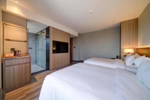 Voodi või voodid majutusasutuse Dujiangyan Yuandong Yaju Hotel toas