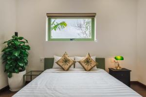 Ένα ή περισσότερα κρεβάτια σε δωμάτιο στο Indochine apartment
